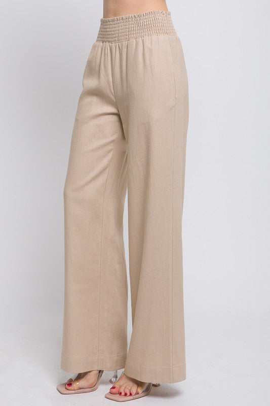 model is wearing Khaki Linen Pants with Smocked Waist with transparent heels 