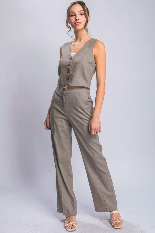 model is wearing Greystone Linen Buttoned Vest Top with matching pants and white heel sandals 
