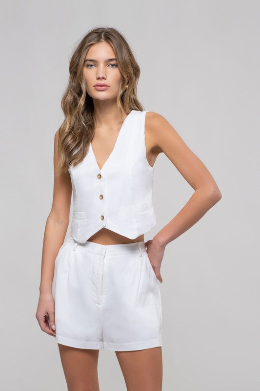 model is wearing White Bermuda Chino Shorts with matching vest