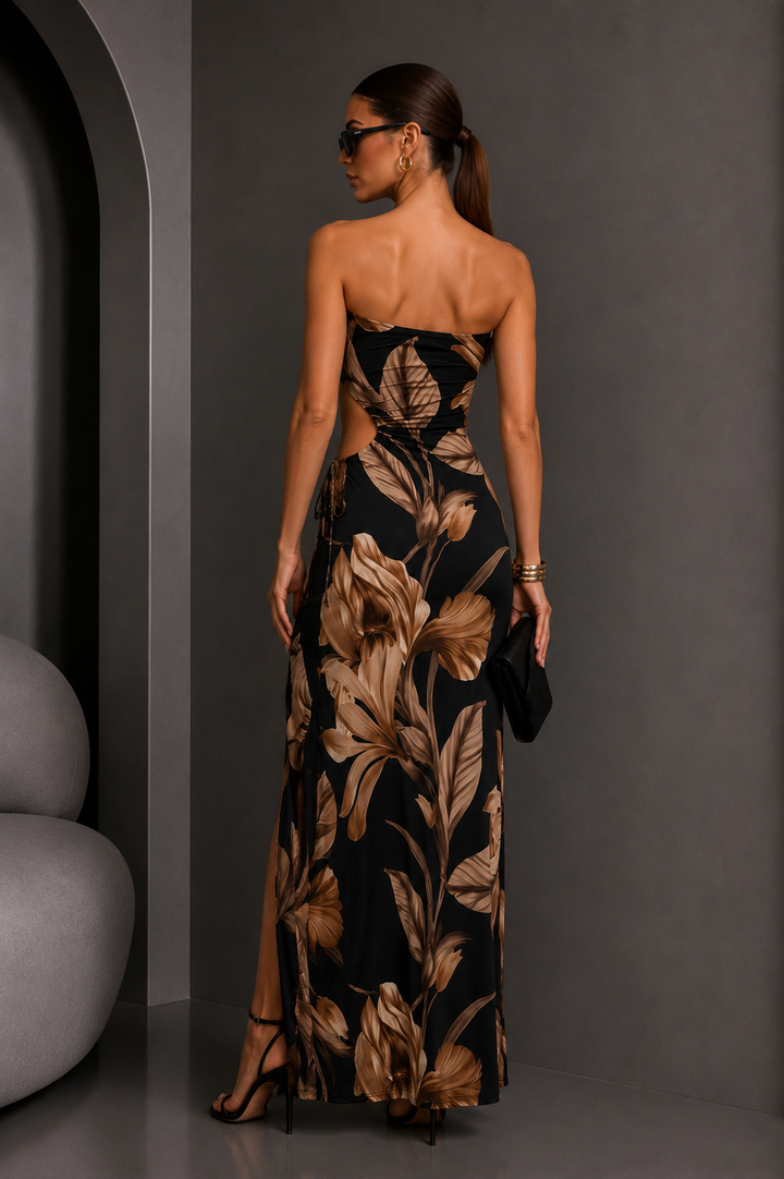 Woman wearing a black floral strapless dress against a gray background