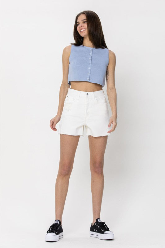 model is wearing White High Rise Mom Short with a blue button crop top and black sneakers