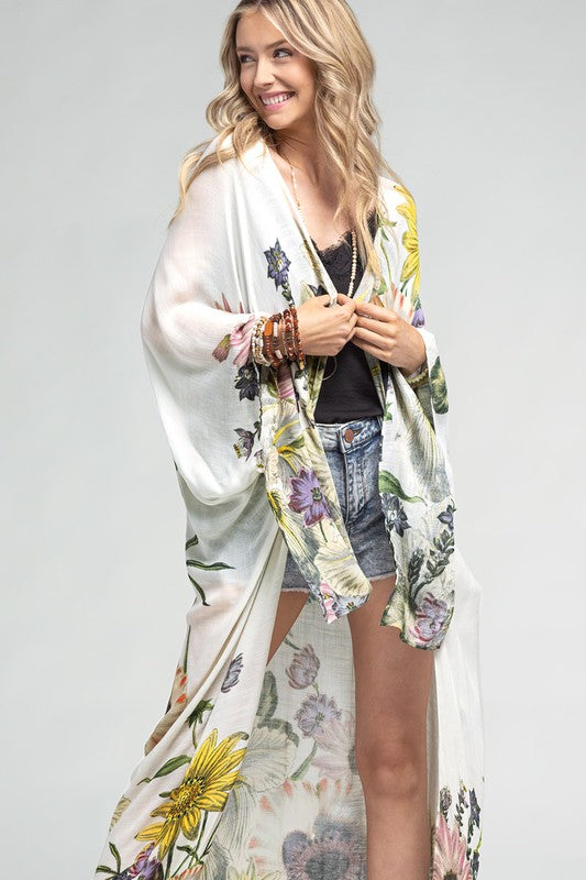 model is wearing Aurelia Airy Floral Duster Kimono with a black top and denim shorts