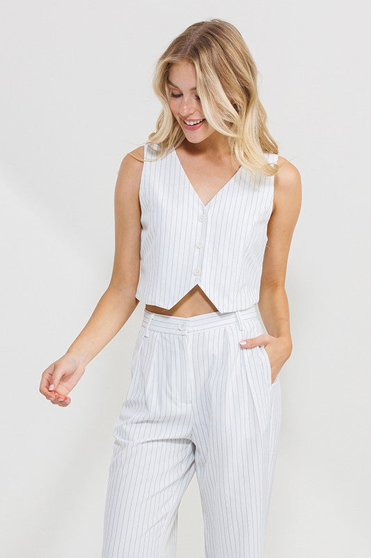 model is wearing Black Stripe Sleeveless Vest Top  and white pants 