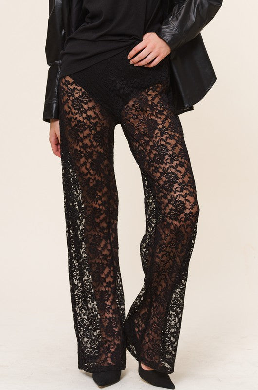 Model is wearing Black Lace Ruby Pants with black heels and matching black top. Front close up view of the pants 
