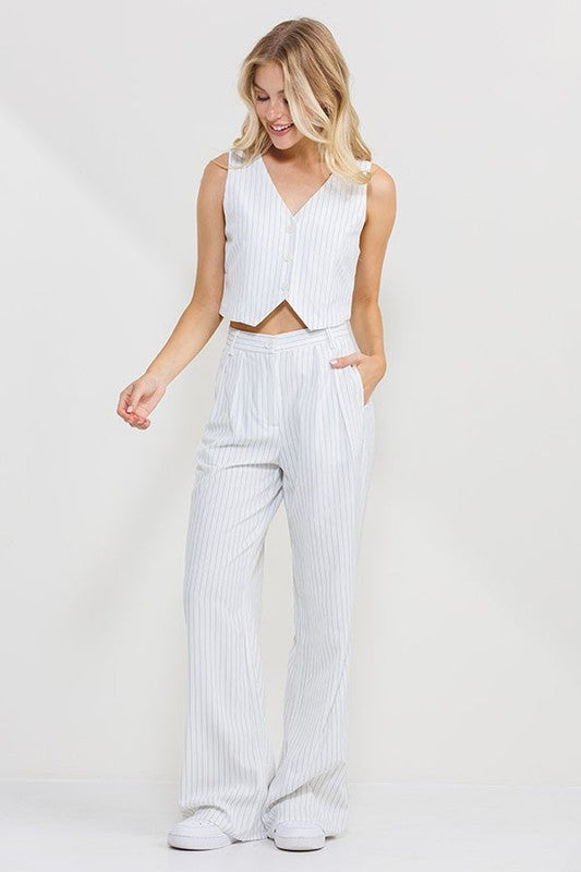 model is wearing White Stripe Long Pants with matching vest top and white sneakers 