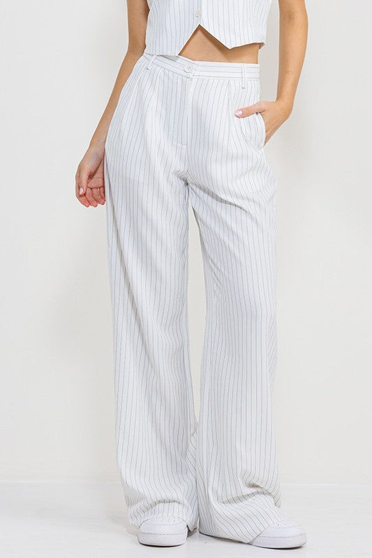 model is wearing White Stripe Long Pants with white sneakers and matching top 