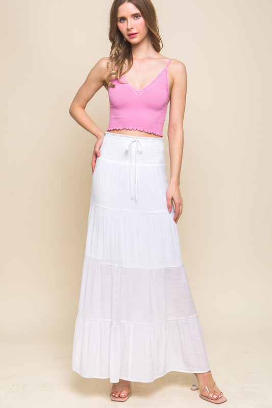 model is wearing White Smocked Maxi Skirt with pink top and heels 