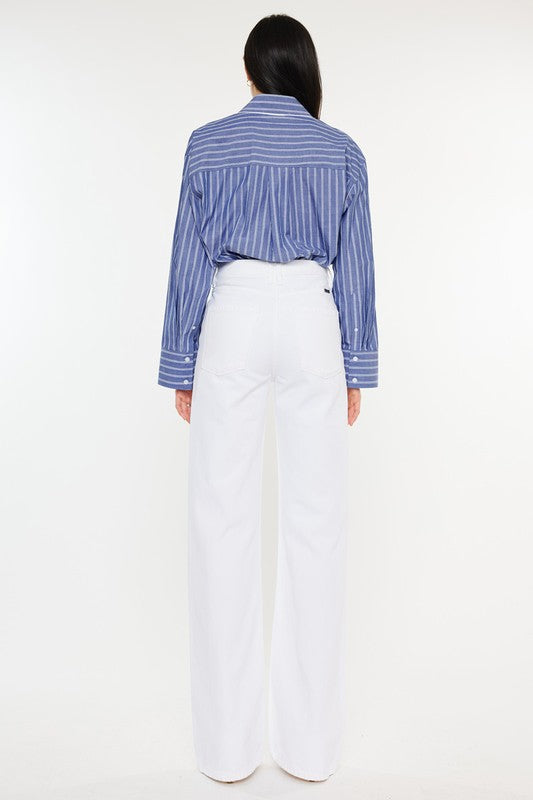 Model is wearing White High Rise Flare Jeans with a blue striped shirt. Back view 