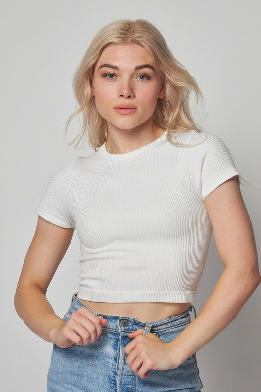model is wearing White Seamless Round Neck Crop Top and denim jeans
