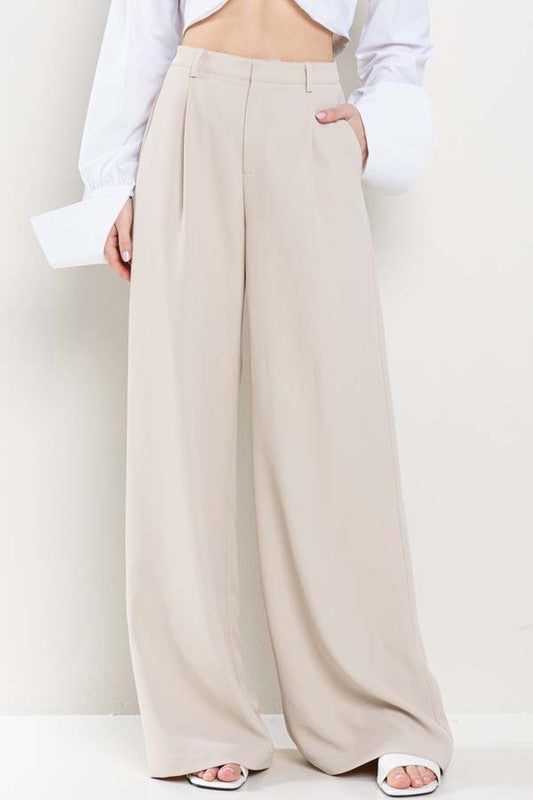 model is wearing Nude Wide Leg Pants with white sandals and white top 