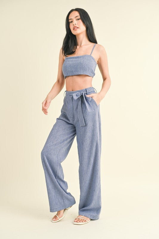 model is wearing model is wearing Blue Crop Top Pants Set and white sandals
