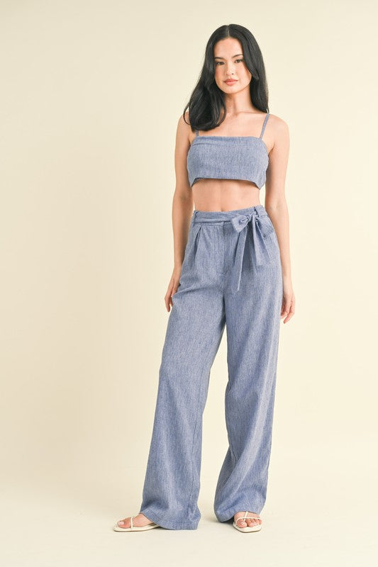 model is wearing Blue Crop Top Pants Set and white sandals
