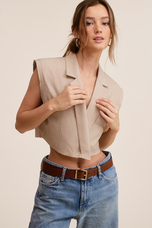 STYLED BY ALX COUTURE MIAMI BOUTIQUE Beige Cooper Vest model is also wearing denim pants and a belt 