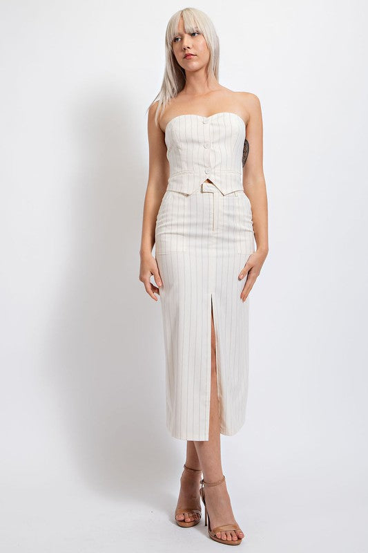 model is wearing Ivory Pinstripe Front Slit Midi Skirt with matching top and beige heel sandals 
