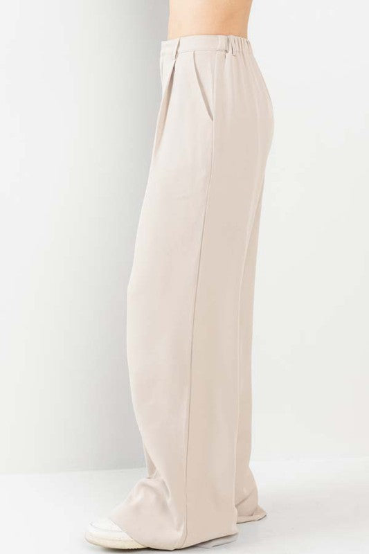 side view of the Nude Wide Leg Pants and white sneakers