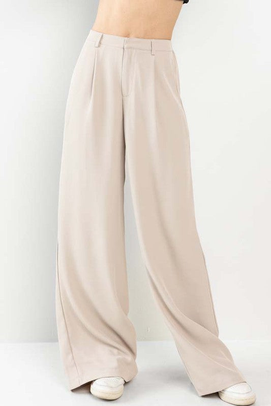 model is wearing Nude Wide Leg Pants and white sneakers