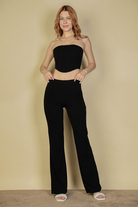 model is wearing Black Corset Flare Pants Set with white sandals