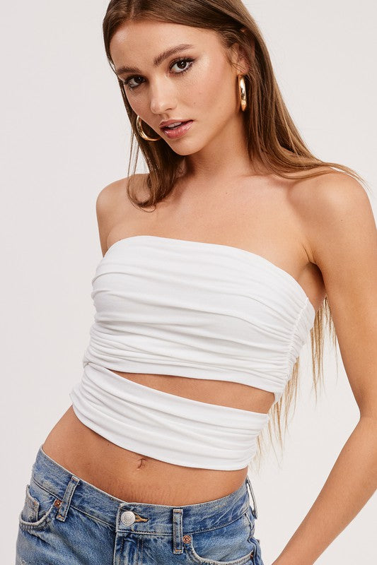 White Strapless cut out crop top with Denim jeans with gold hoop earrings