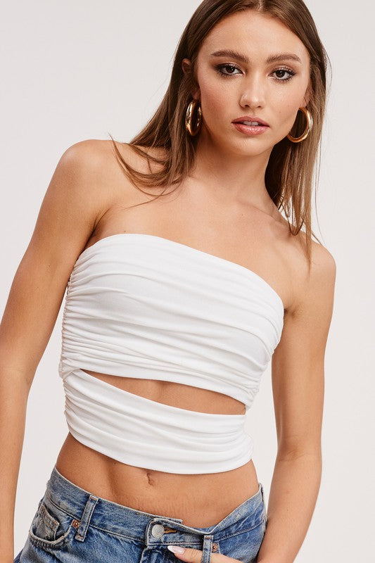White Strapless cut out crop top with Denim jeans with gold hoop earrings