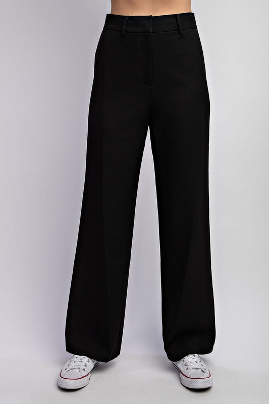 STYLED BY ALX COUTURE MIAMI BOUTIQUE Model is wearing Black Tailored Woven Pants and white sneakers, front view of the pants 