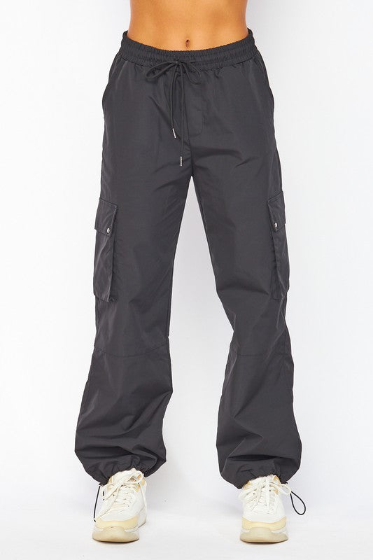 model is wearing Black Parachute Cargo Pocket Pants and white sneakers 