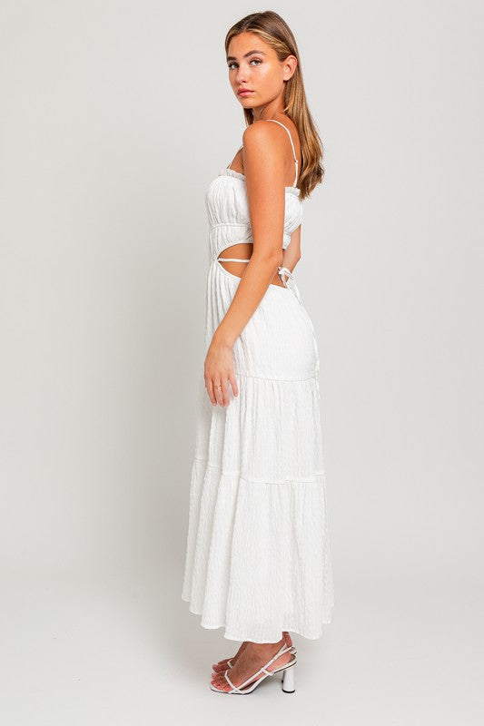 side view of the White Spaghetti Ruffle Maxi Dress with white high heels sandals
