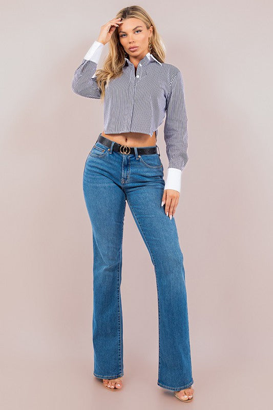 model is wearing Black Striped Constrasted Blouse  with a black belt, straight denim jeans and heels 
