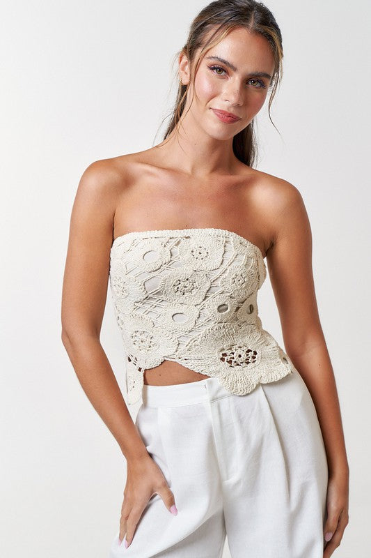 Model is wearing Natural Crochet Flyway Tube Top with white trousers 
