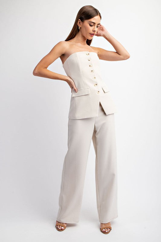 model is wearing Natural Tailored Bustier Top with matching pants and beige heel sandals 