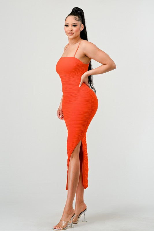 STYLED BY ALX COUTURE MIAMI BOUTIQUE Model is wearing Orange Lux Ruched Mesh Layer Side Open Slitted Midi Dress side view 