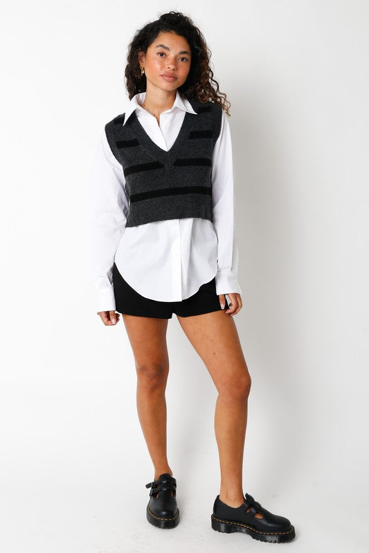 model is wearing Black Lily Shorts with a white shirt and black striped vest over the shirt with black loafers