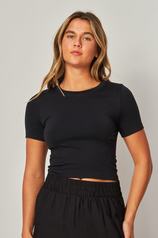 Model is wearing Black Seamless Crew-neck Crop Top and matching pants 