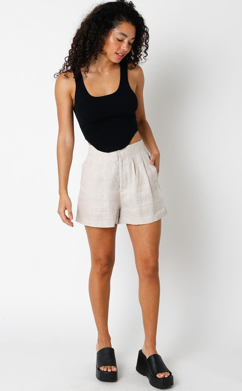 model is wearing Khaki Jolie Linen Shorts with a black crop top and black platform sandals 