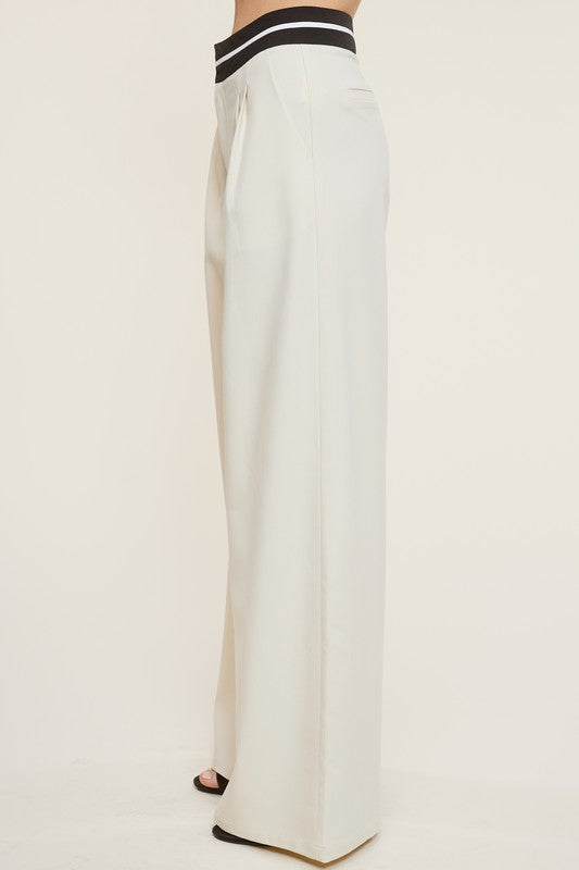 Side view of the Cream Talbot Trousers and black heels 