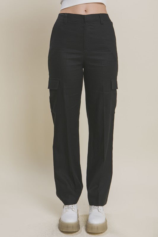 Model is wearing Black Linen Cargo Pants  and white sneakers 