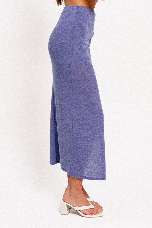STYLED BY ALX COUTURE MIAMI BOUTIQUE Model is wearing Blue Surplice Maxi Skirt with white heels. Side view