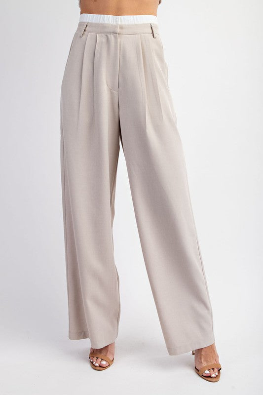 model is wearing Taupe Tailored Elastic Waist Pants with beige heels 