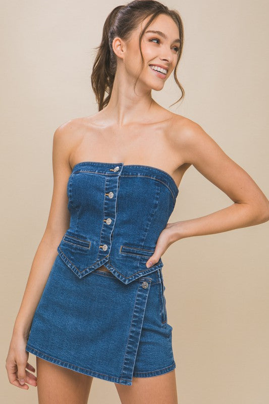 model is wearing Blue Denim Strapless Button-Up Top with matching mini skort 