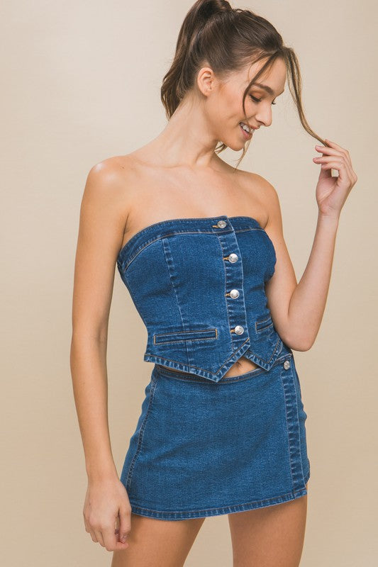 model is wearing Blue Denim Strapless Button-Up Top with a matching mini denim skirt 