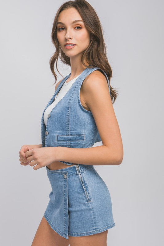 side view of the model wearing Light Denim Buttoned Vest Top a white top and matching skort 