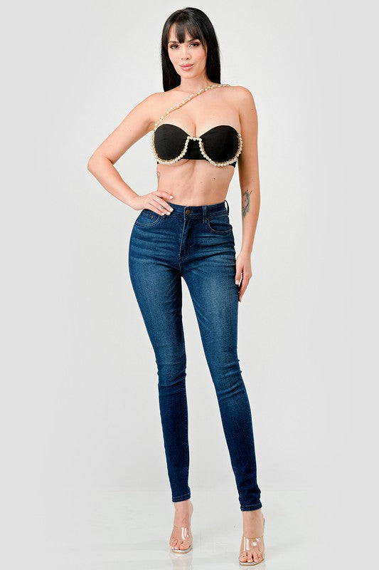 STYLED BY ALX COUTURE MIAMI BOUTIQUE Model is wearing Black Luxe Pearl Trim Sweetheart Bralette Cropped Top  with denim skinny jeans and high heels 
