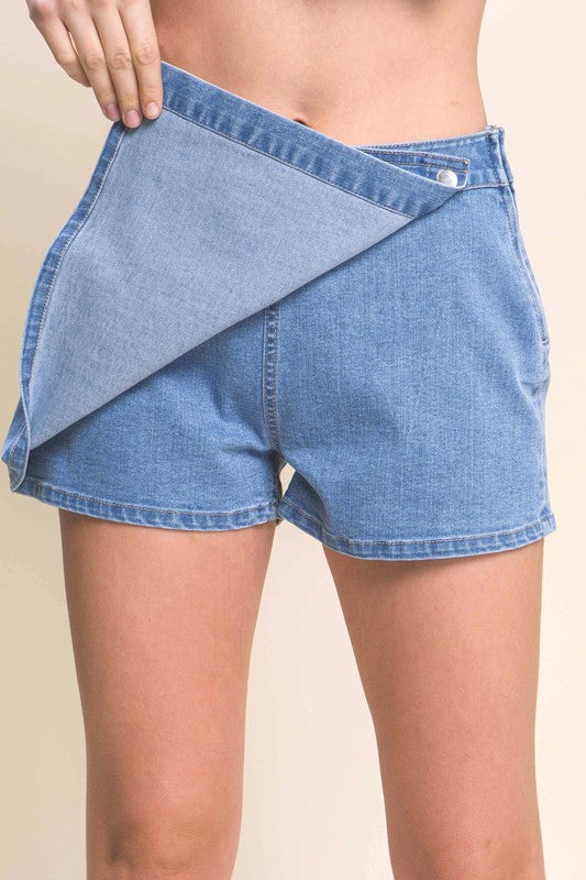 model wearing and showing the short behind the front lap of the Light Denim Snap-On Button Skorts