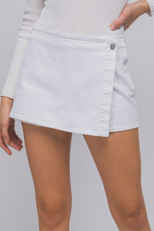 model is wearing White Denim Snap-On Button Skorts