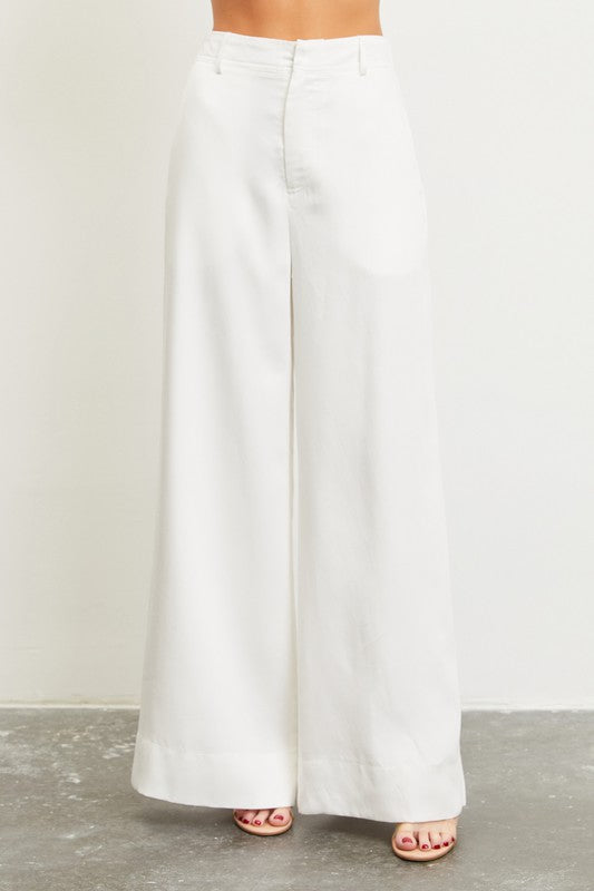 Model is wearing White High Waist Elastic Back Pants and sandals