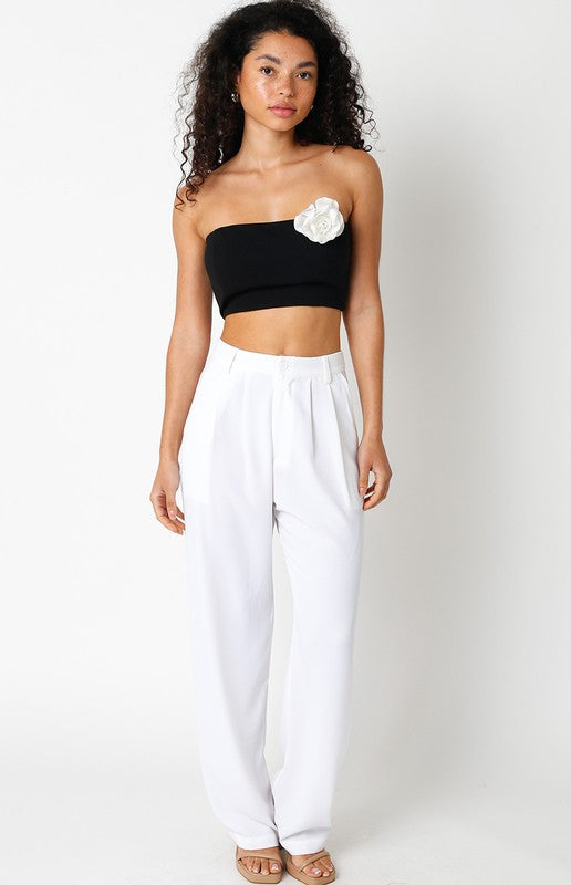 model is wearing Black Rosie Top with white trousers and beige sandals 