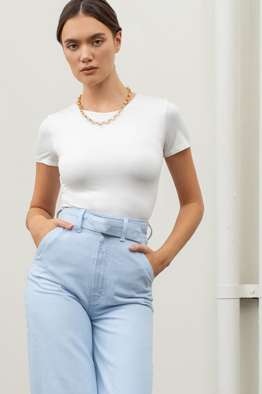 model is wearing White Reversible Round Neck Crop Top with blue pants