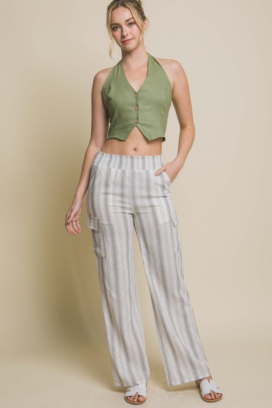model is wearing Olive Linen Cropped Vest  and striped cargo pants with white sandals 