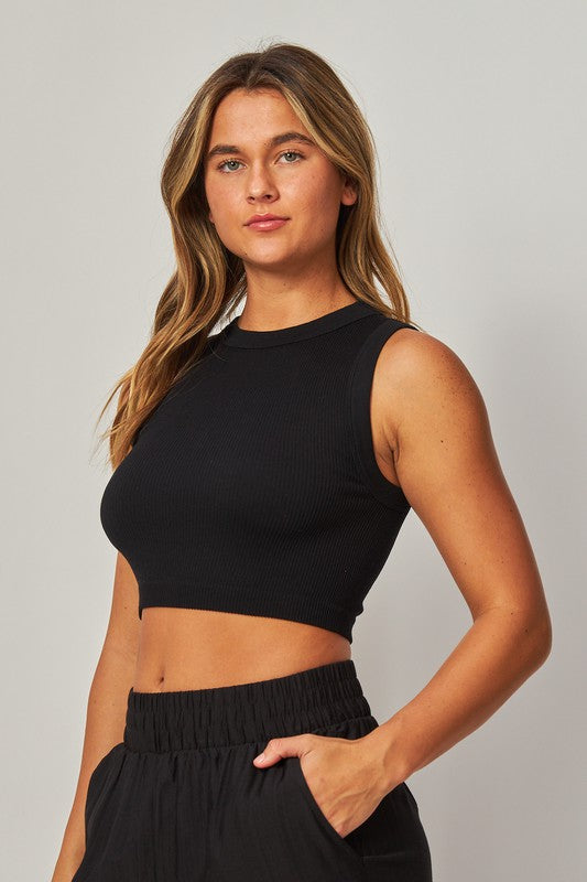 Model is wearing Black High Neck Crop Top with matching black pants