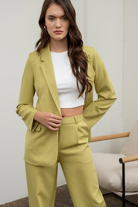 model is wearing a matching kiwi blazer with a white top and the Kiwi High Waisted Wide Leg Slacks