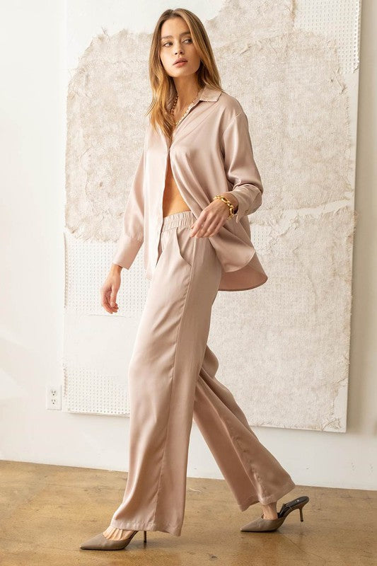 model is wearing Light Taupe Satin Bell Bottom Pants with matching top and taupe sude heels 